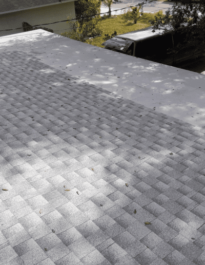 A shingled roof with a car parked on it.
