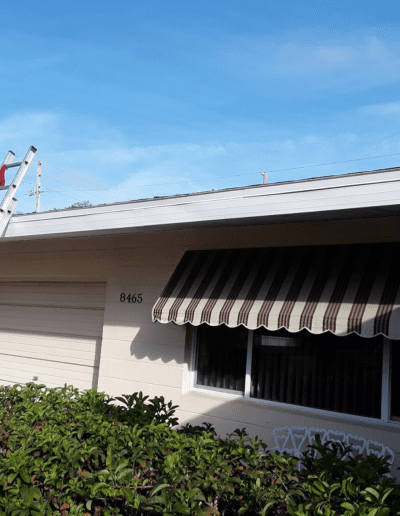 A ladder is on the roof of a house.