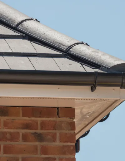 The roof of a house with a gutter on it.