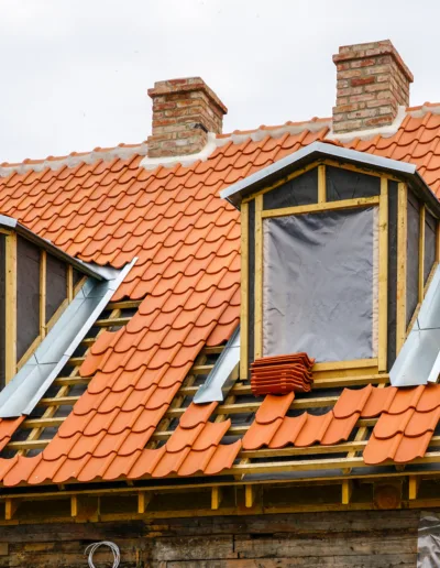 A house with a roof that is being re-tiled.